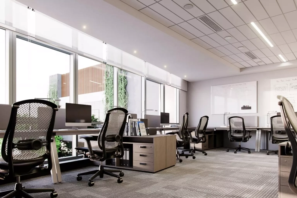 Oficina interna amueblada en el edificio de vertis color blanco con techo de tabla yeso con lamparas empotrada led.